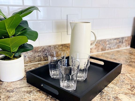 Experience kitchen design at its best with subway tile backsplash and granite-style countertops, inspiring your culinary creativity.