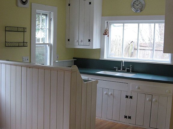 Eat-in Country Kitchen with custom cabinets and cozy woodstove