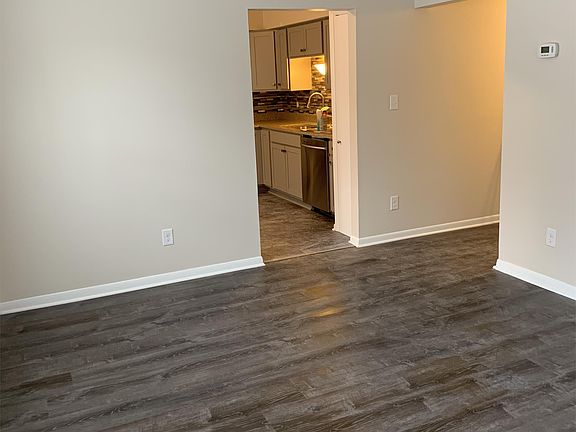 Living room area looking into kitchen.