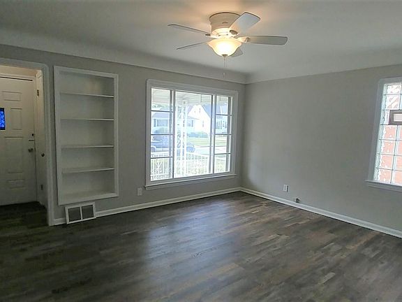 Large living room with closet in vestibule. Book case to show family pictures or collectibles.