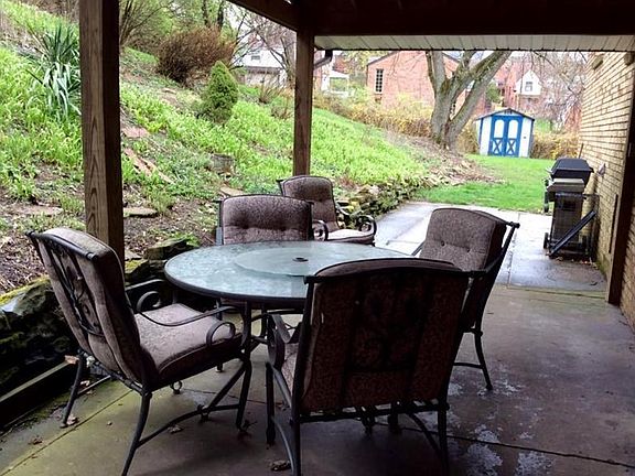 The covered patio is almost ready for its favorite season! Spacious area for entertaining and a gard