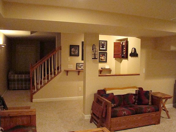 view of basement looking to large office or play area with closet
