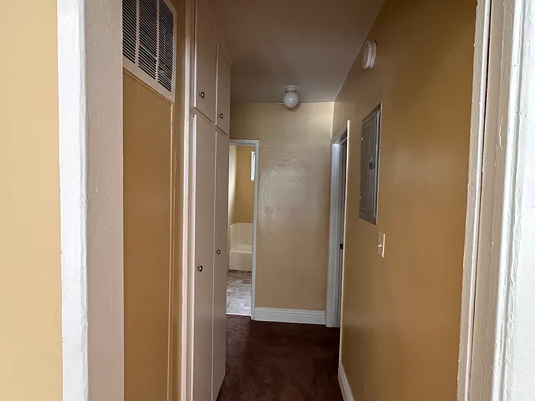 Hallway w/ linen closets. Entrance to bedrooms.