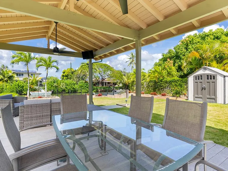 Longer view of the Lanai including the outdoor dining table.