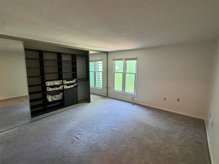 Master Bedroom includes floor to ceiling glass mirror doors with custom California Closet