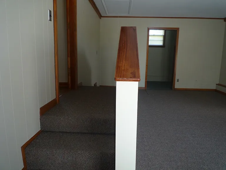 Converted garage made spacious bonus room for living, office or 4th bedroom. See Laundry room at back through open door with lots of great storage space.