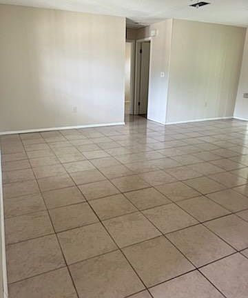 Living room, dining room to the right. Patio doors lead to screen room off dining room