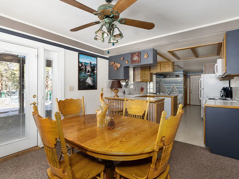 Downstairs dining table 2 of 2 with beautiful outdoor views and backyard entrance.