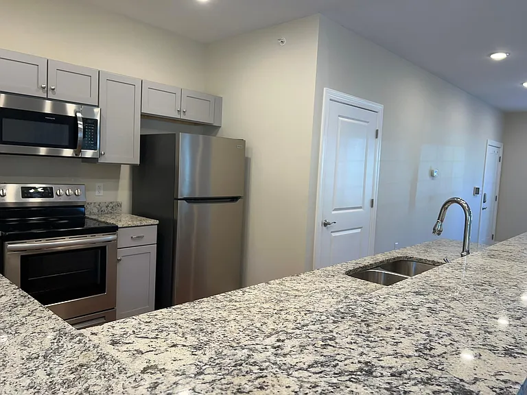 The large kitchen has long granite countertops, a pantry and abundant cabinetry along with a full suite of appliances.