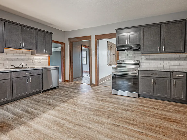 New cabinets and backsplash, luxury vinyl plank flooring