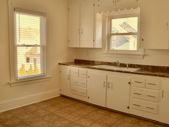 Sunny, large kitchen with lots of cabinet space and room for a table and chairs.