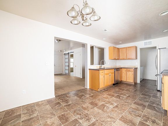 Kitchen with view into living area and office / downstairs BR