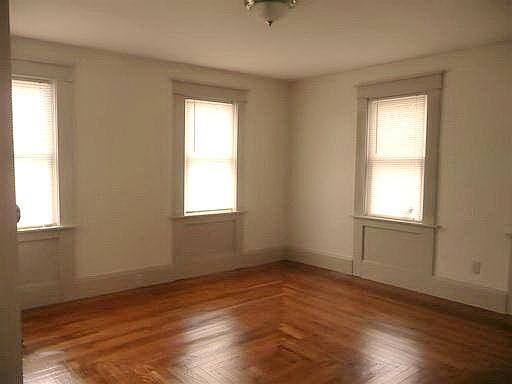 First floor large Bedroom sports a pretty floor and window detailing.