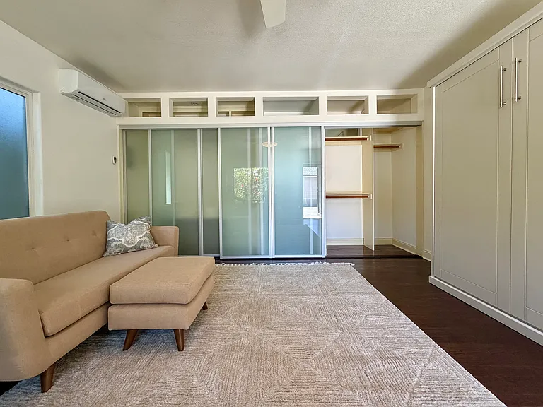 View of glass sliding wall and closet space.