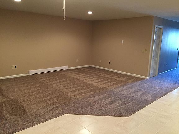 This is the living room. It is a large open area combined with the kitchen. The angled area of the tile is where the dining table sits. This is what you see when you walk into the apartment. There is a/c and ceiling fans.