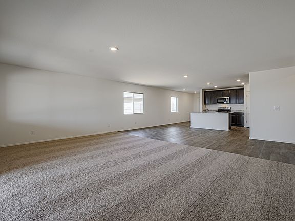 Open family room connected to the dining area and kitchen.