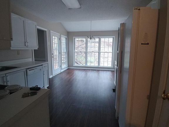 Large Kitchen with dining area surrounded by windows 