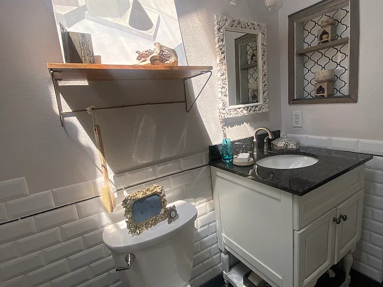 Bathroom with vaulted ceiling and amazing skylight...lighting changes throughout the day and sometimes you can peek the full moon in the evening!