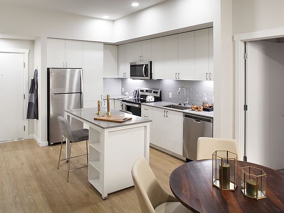 Phase II - Scheme C Kitchen with white cabinetry, grey tile backsplash, and stainless steel appliances