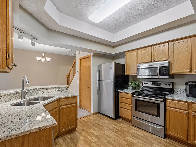 Large Kitchen with Upgraded Premier Granite, Stainless-Appliances, Breakfast Bar.