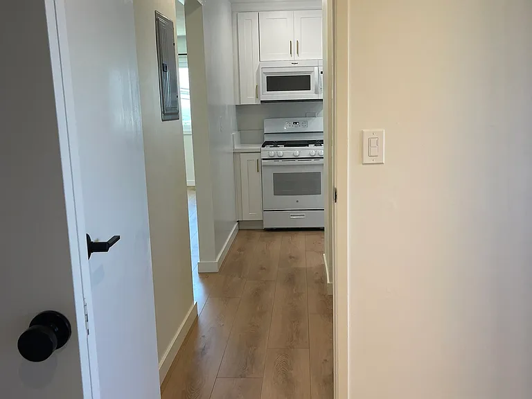 View from larger bedroom towards kitchen.