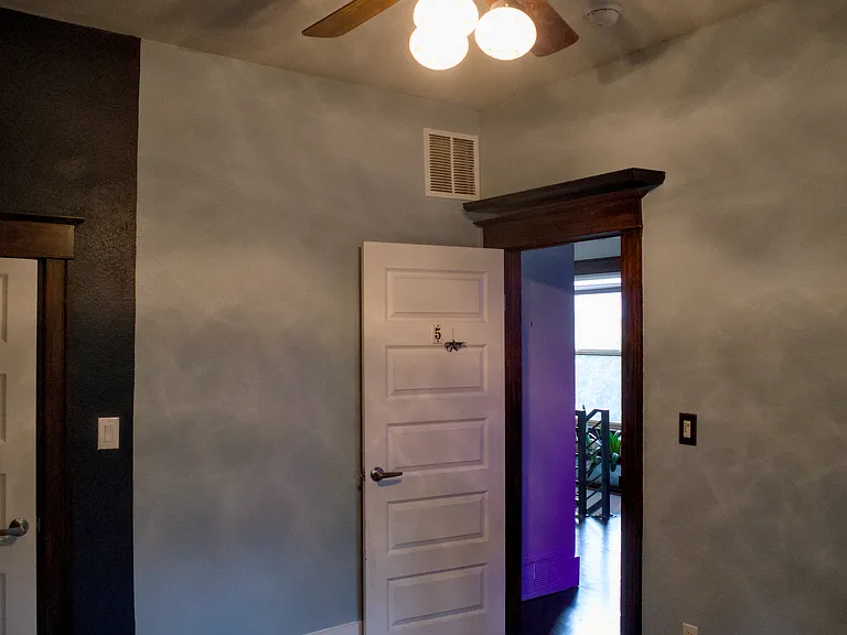 your room viewed from the southeast corner with crystal lamp and fan