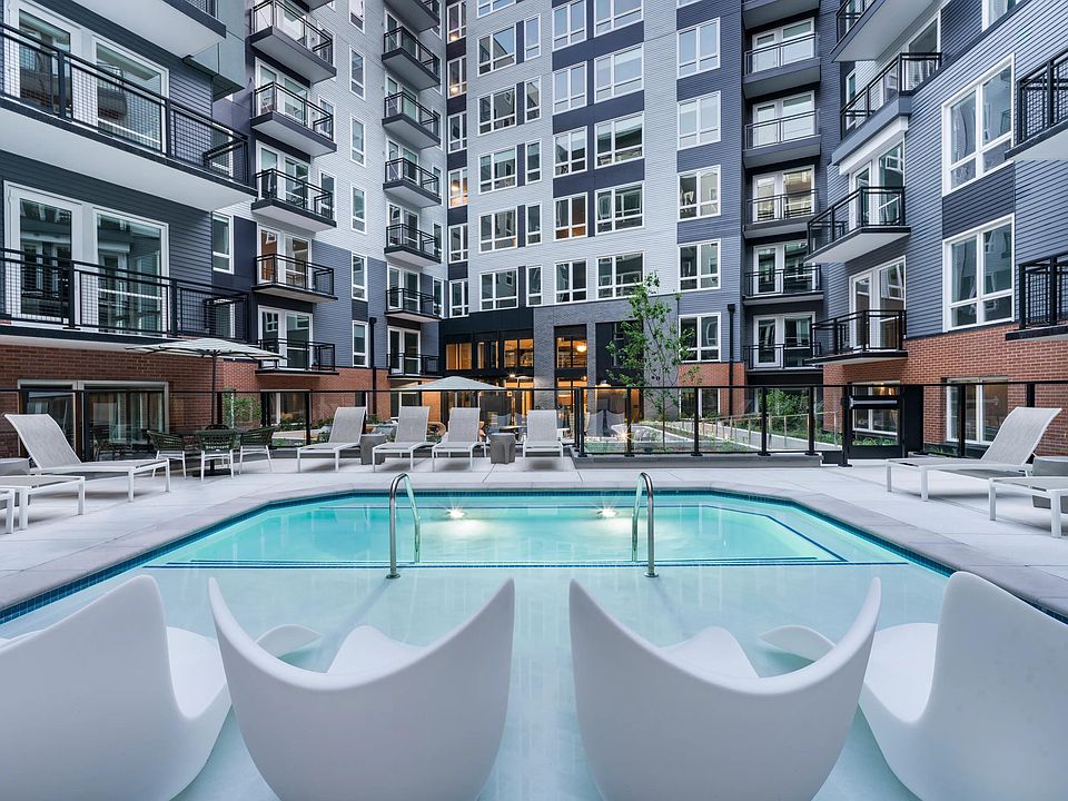 Soak, sun, and unwind in our resort-style courtyard pool, complete with in-water loungers, private seating, and a peaceful city backdrop.