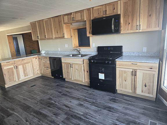 Newly remodeled kitchen with dishwasher, micro-hood, and quartz countertops
