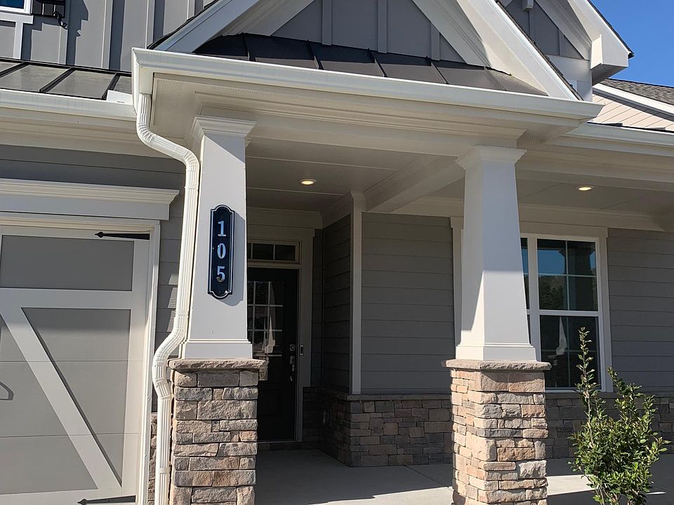 Home exterior. 2 car garage with driveway. Landscaping maintained by HOA.