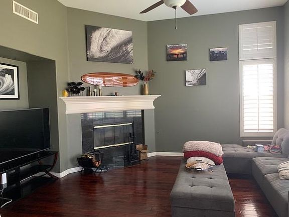 Family room with wood floors, fireplace with gas starter