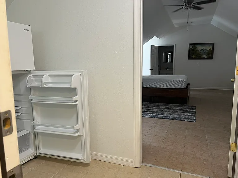 Full-sized refrigerator with top freezer, bedroom vaulted ceilings