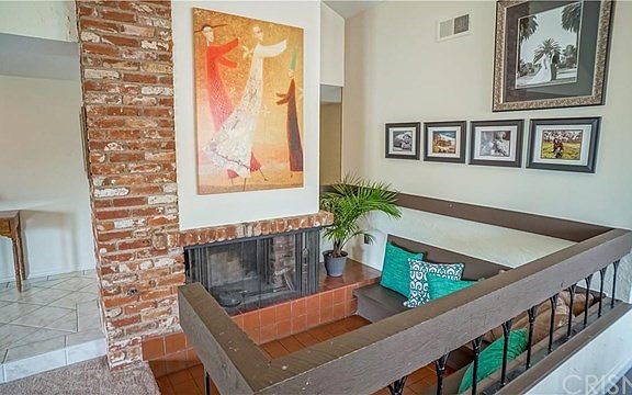 Fireplace with cozy step down conversation area.