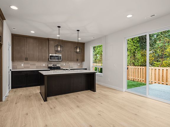 Spacious kitchen and sliding glass door leading from great room to outdoor patio