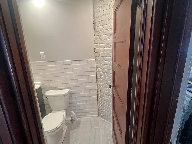 bathroom with exposed brick chimney