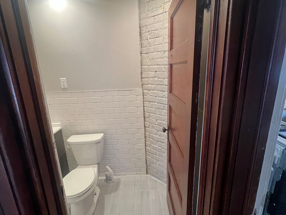 bathroom with exposed brick chimney