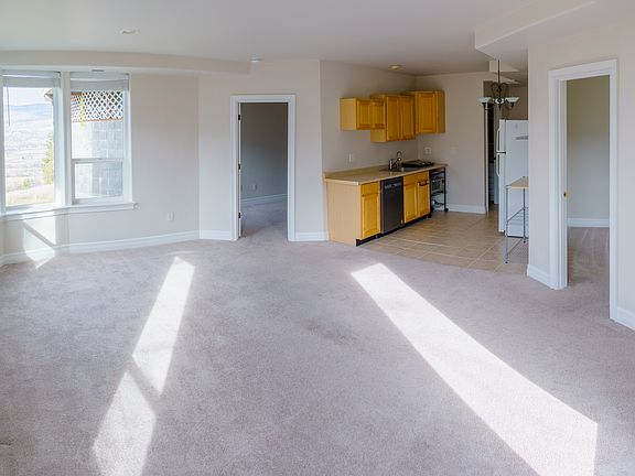 View of kitchen from living room. Doors to office and bedroom.