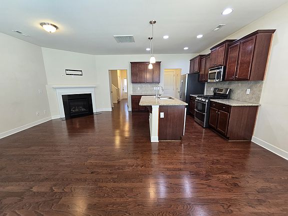 Back door looking into open-plan great room and kitchen