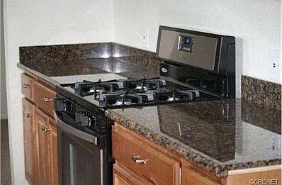 Kitchen includes granite counters and brand new appliances.