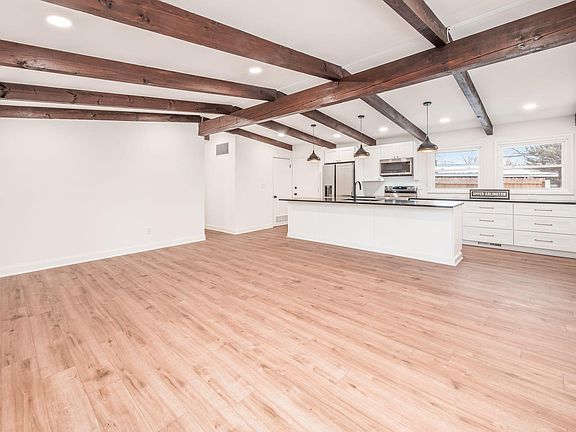 Living Room: Vaulted Ceilings, Wooden Beams, Dimmable Recessed Lighting, LVP Waterproof Flooring, Open Floor Plan