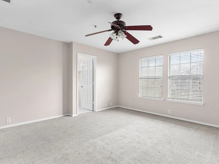 Primary Bedroom with ceiling fan, spacious closet and updated bathroom with large shower