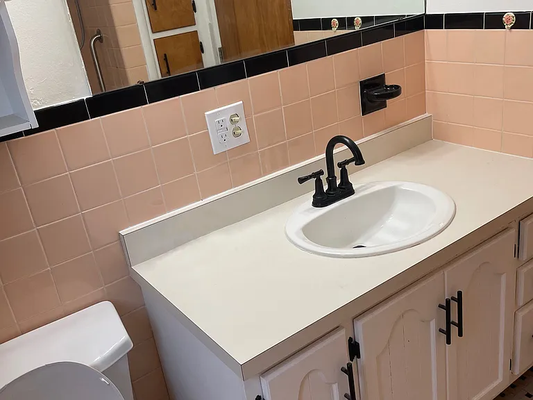 Floor to ceiling linen closet is opposite the sink
