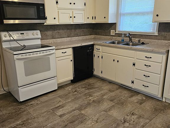 Kitchen with Smooth top Stove, Microwave, and Dishwasher