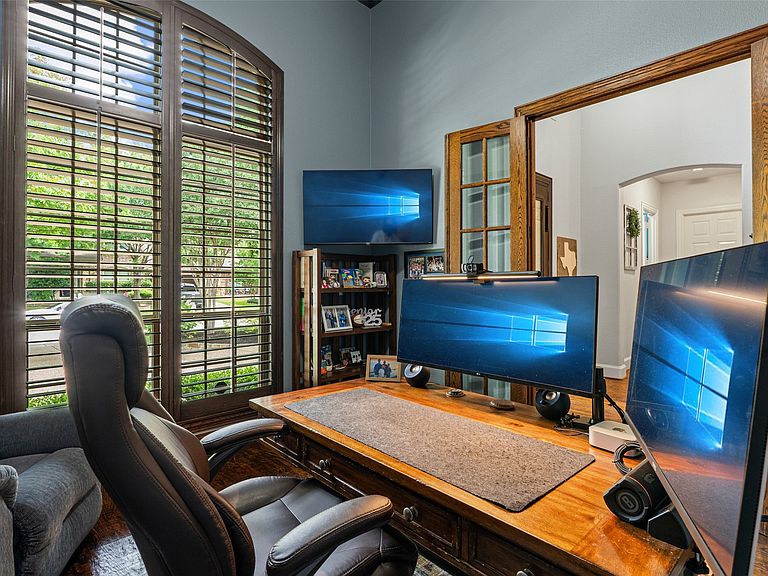 Private first-floor study with built-ins and plantation shutters