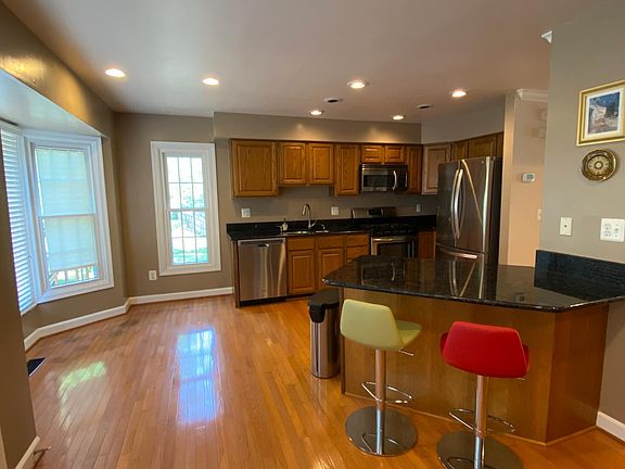 Kitchen with black granite counter tops and island