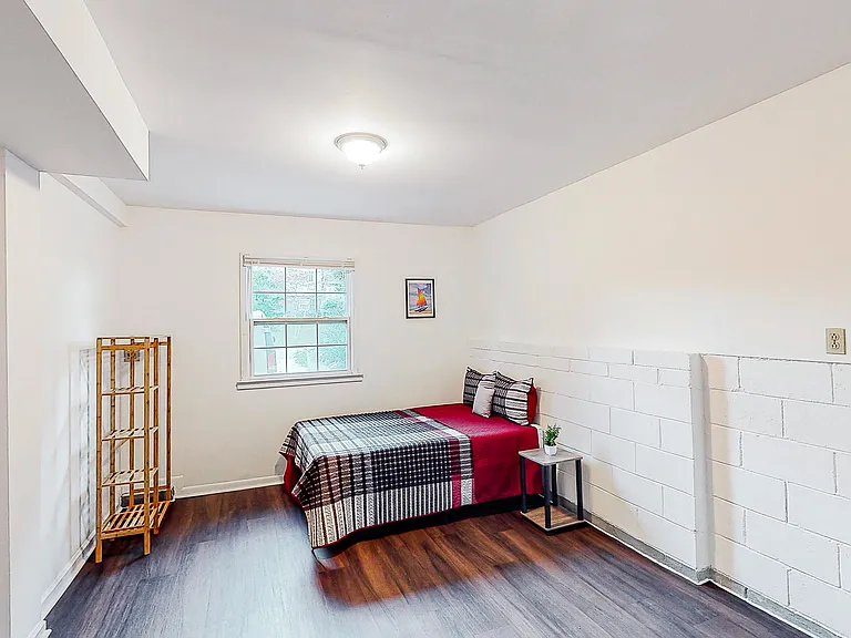 spacious room with brick accent wall