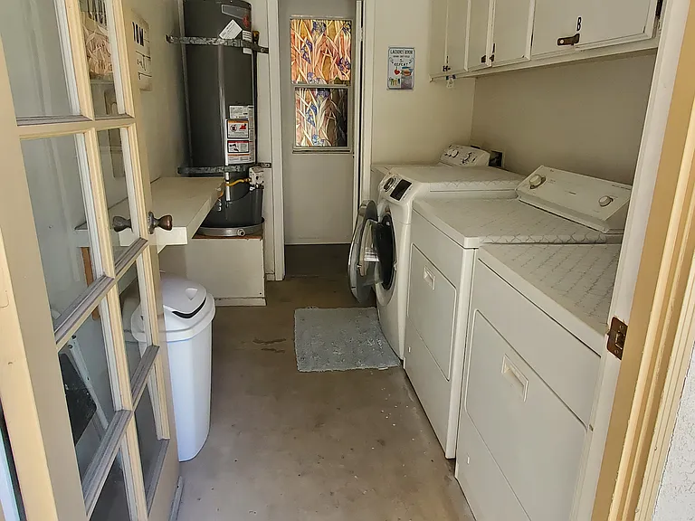 Shared laundry with 2 washers & 2 dryers and one cabinet for each apartment