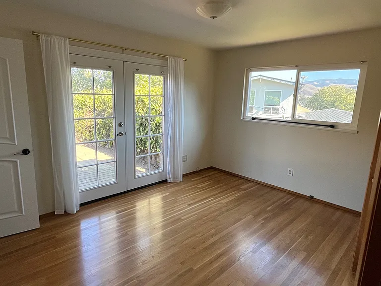 Primary Bedroom with french doors to backyard