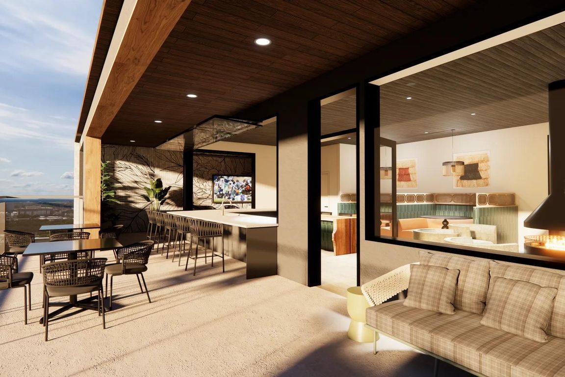 Rooftop sky lounge with an indoor/outdoor covered patio with views of the downtown Dallas skyline and Deep Ellum.