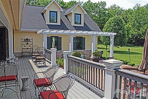 Wow!  A partially-covered back porch/deck and a patio with a pergola.  Check out the maintenance-free decking and hardiboard.