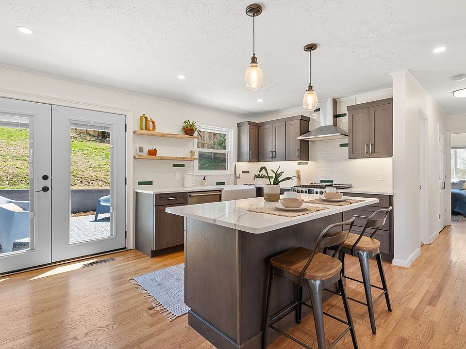 Brand new kitchen with stainless steel appliances, large central island and access to back patio